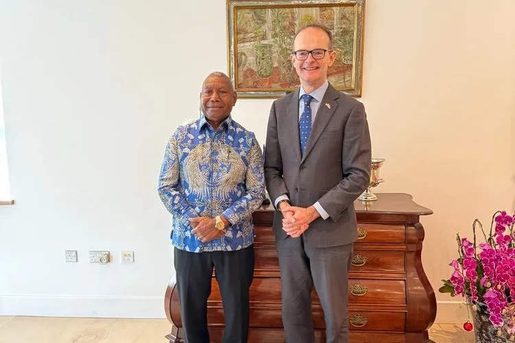 West Papua Governor Dominggus Mandacan and British Ambassador Dominic Jermey shaking hands during a formal meeting at the British Ambassador's residence in Jakarta.